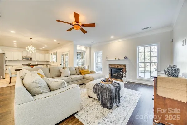 a living room with furniture fireplace and a window