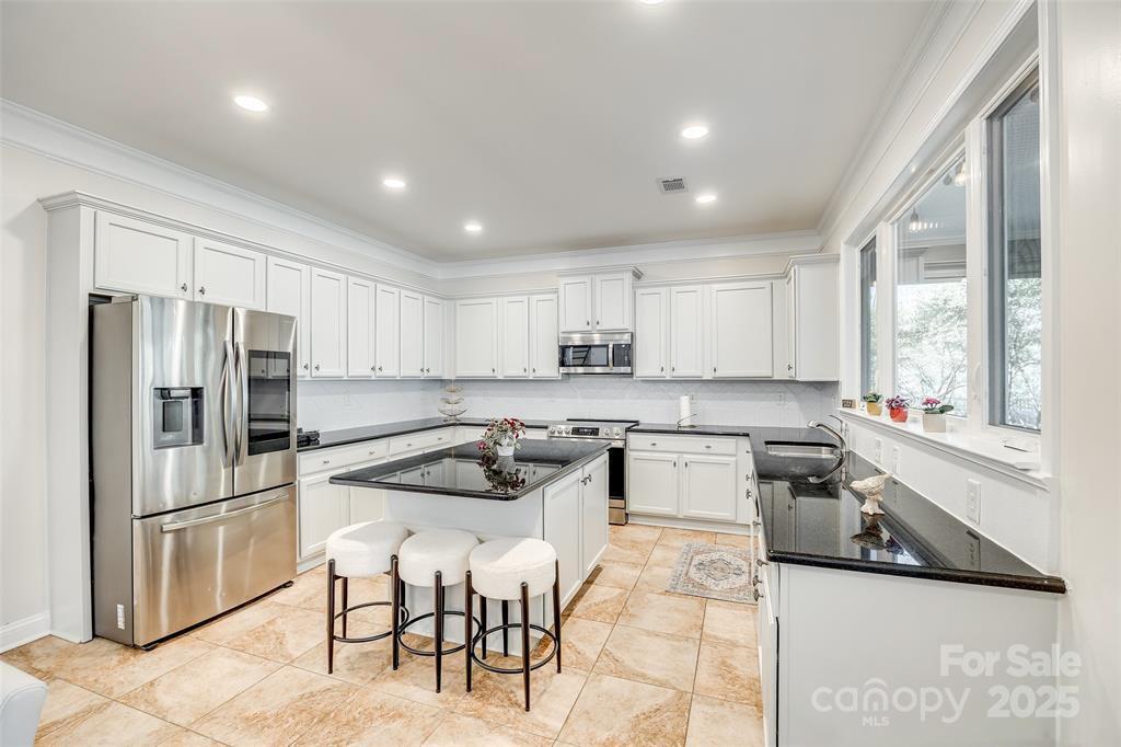 4005 Sedgewick Road Indian Trail, NC 28079 - Photo 10 of 38 a kitchen with a refrigerator and a stove top oven
