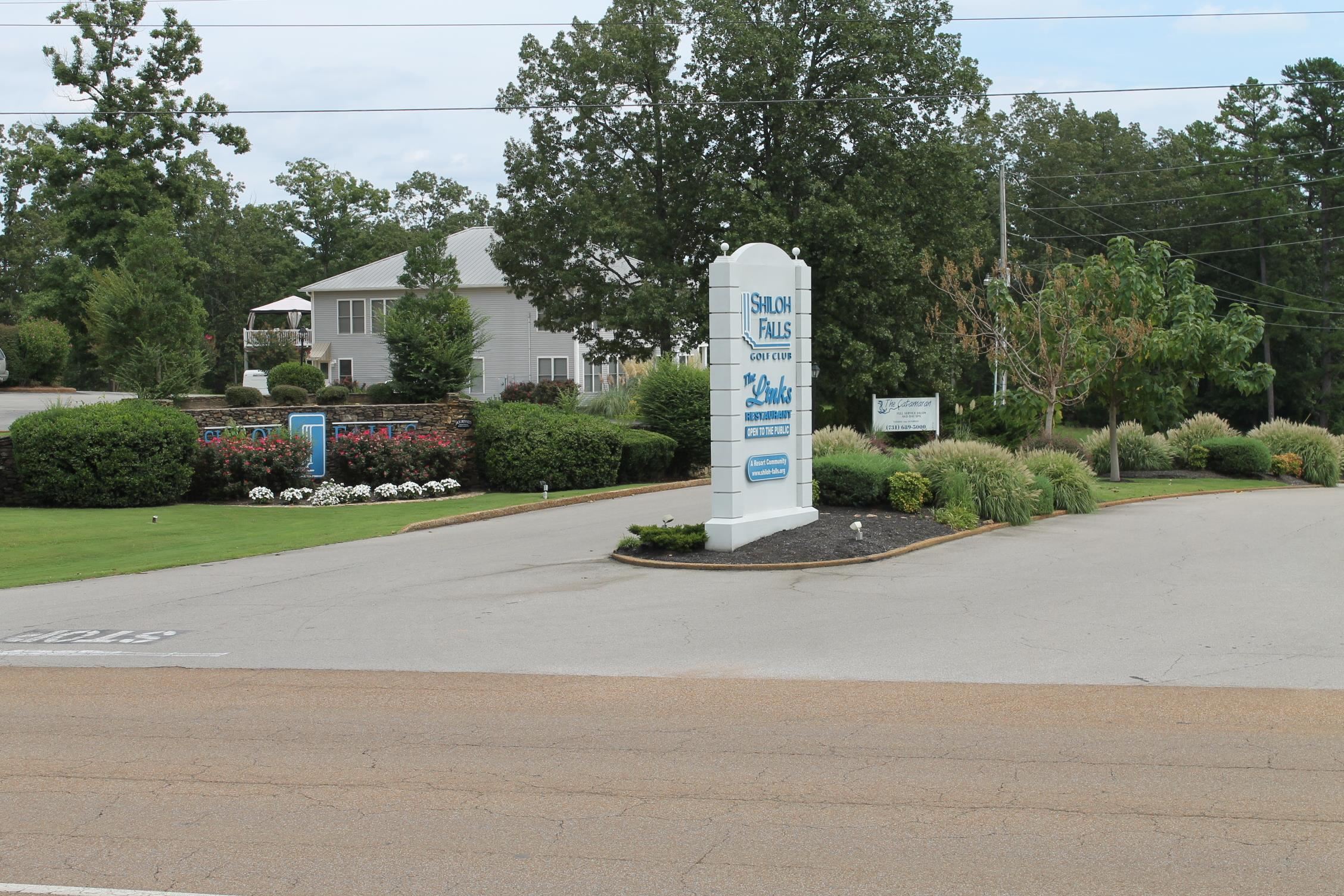 180 Vantage Pointe Counce, TN 38326 - Photo 30 of 30 a sign board with flower plants and large trees