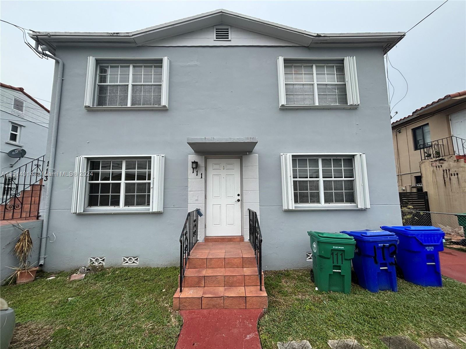 111 Southwest 31st Court, Unit 1 Miami, FL 33135 - Photo 14 of 14 a front view of brick house with a yard