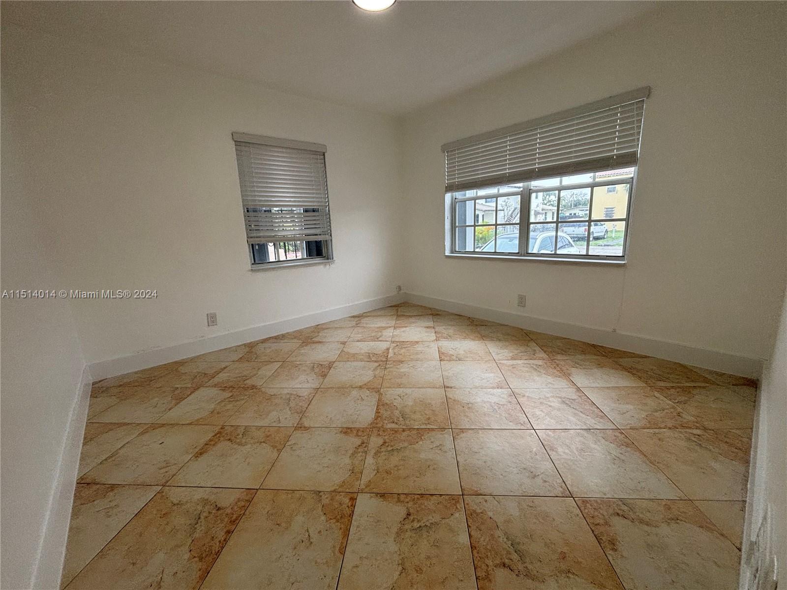111 Southwest 31st Court, Unit 1 Miami, FL 33135 - Photo 4 of 14 a view of an empty room with a window