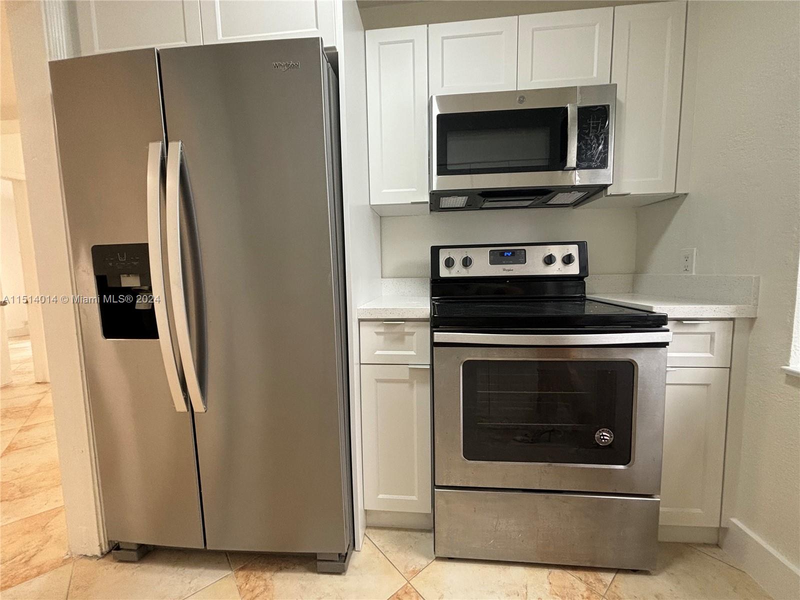 111 Southwest 31st Court, Unit 1 Miami, FL 33135 - Photo 7 of 14 a stove top oven sitting inside of a kitchen