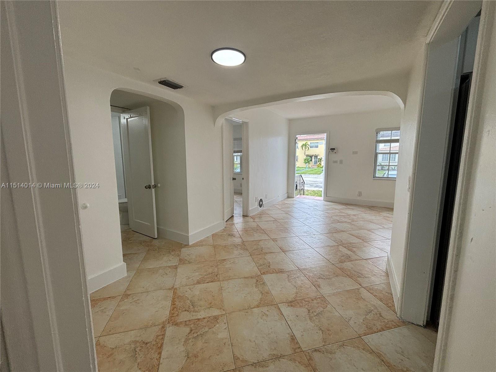 111 Southwest 31st Court, Unit 1 Miami, FL 33135 - Photo 8 of 14 a view of a hallway with wooden floor and a bathroom