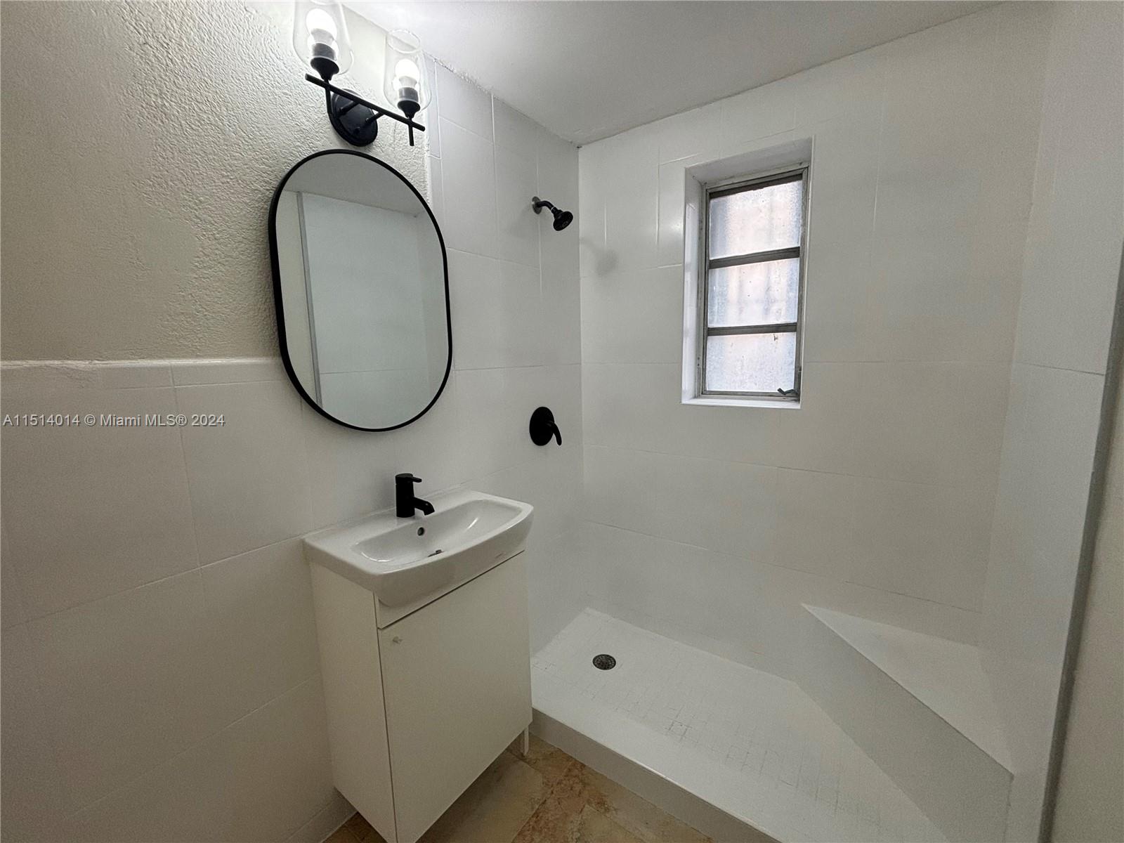 111 Southwest 31st Court, Unit 1 Miami, FL 33135 - Photo 9 of 14 a bathroom with a sink a toilet and a bathtub