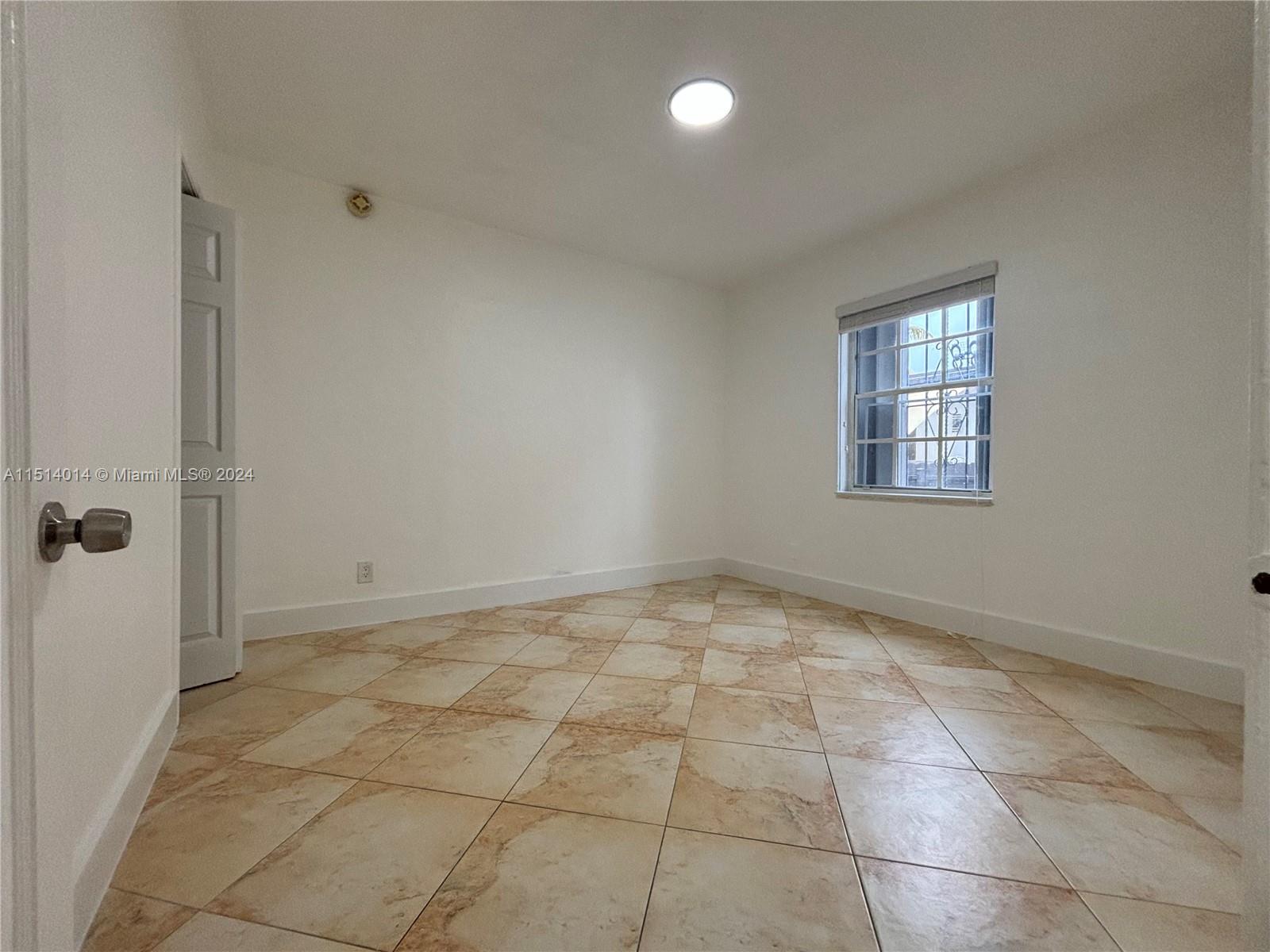 111 Southwest 31st Court, Unit 1 Miami, FL 33135 - Photo 10 of 14 a view of an empty room and window