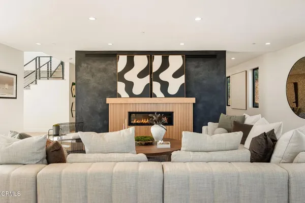 a living room with furniture and a fireplace