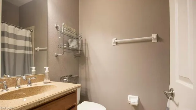 a living room with furniture a clock and a flat screen tv