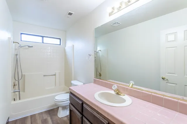 a bathroom with a sink toilet and shower