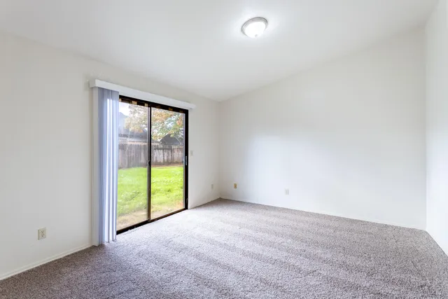 an empty room with an empty space and windows