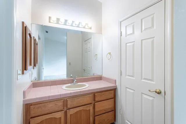 a bathroom with a sink vanity and a mirror