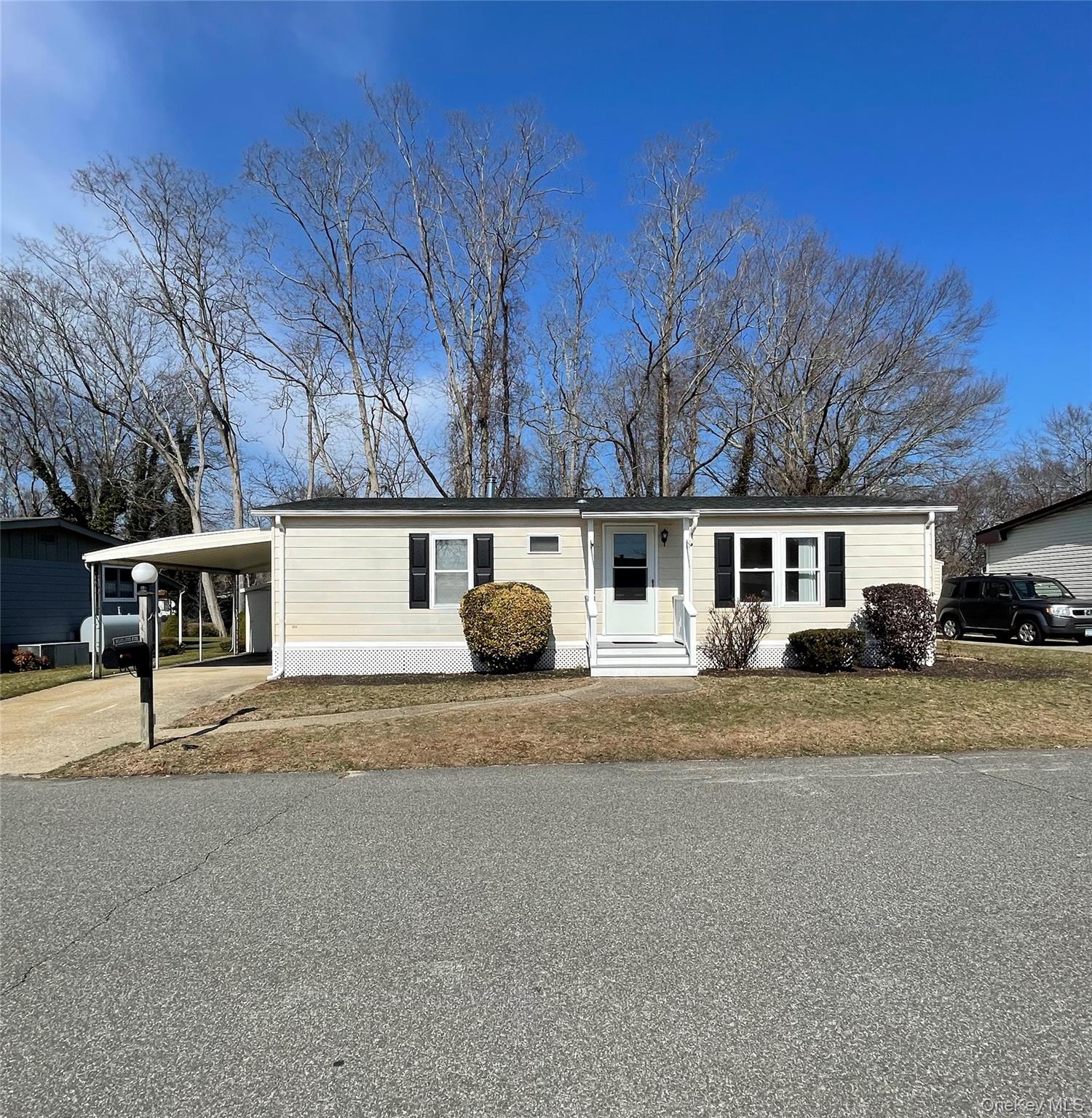 1661 Old Country Road, Unit 398 Riverhead, NY 11901 - Photo 1 of 14 a view of street with residential houses