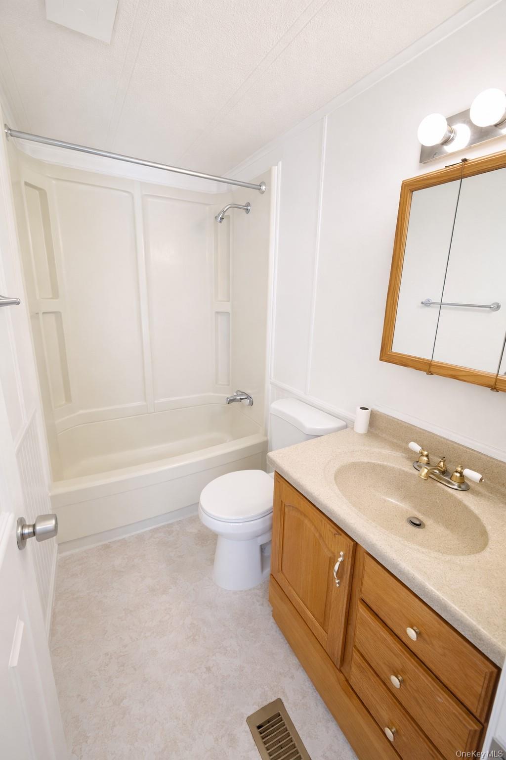 1661 Old Country Road, Unit 398 Riverhead, NY 11901 - Photo 13 of 14 a bathroom with a sink a toilet and shower