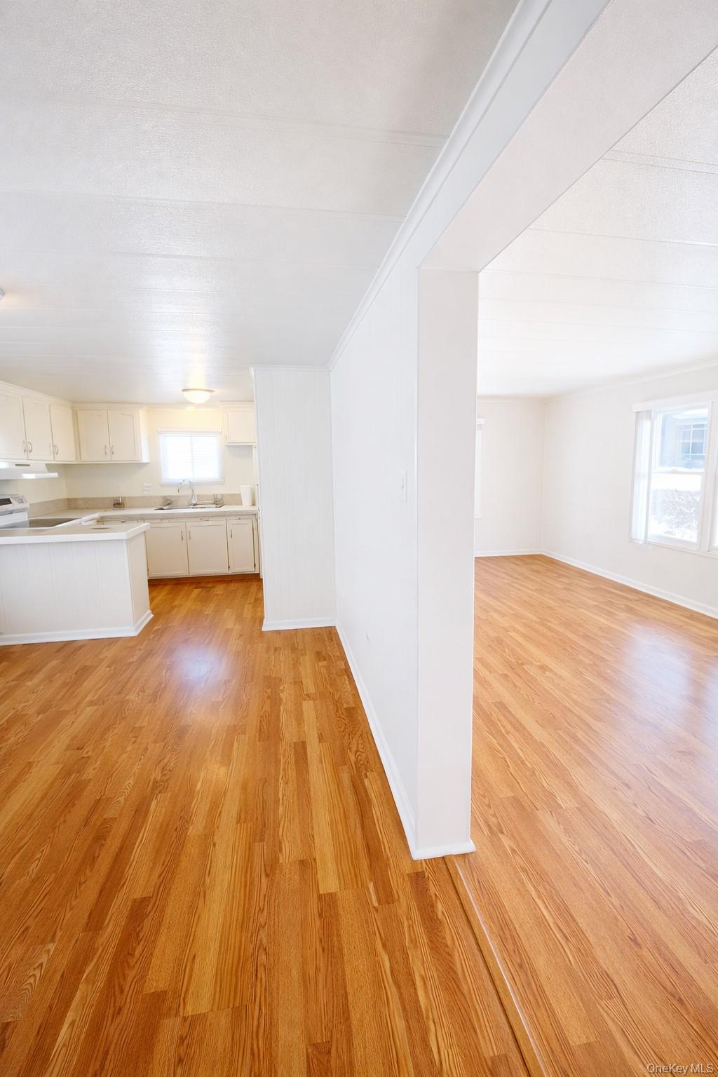 1661 Old Country Road, Unit 398 Riverhead, NY 11901 - Photo 5 of 14 a view of a kitchen with wooden floor and a sink