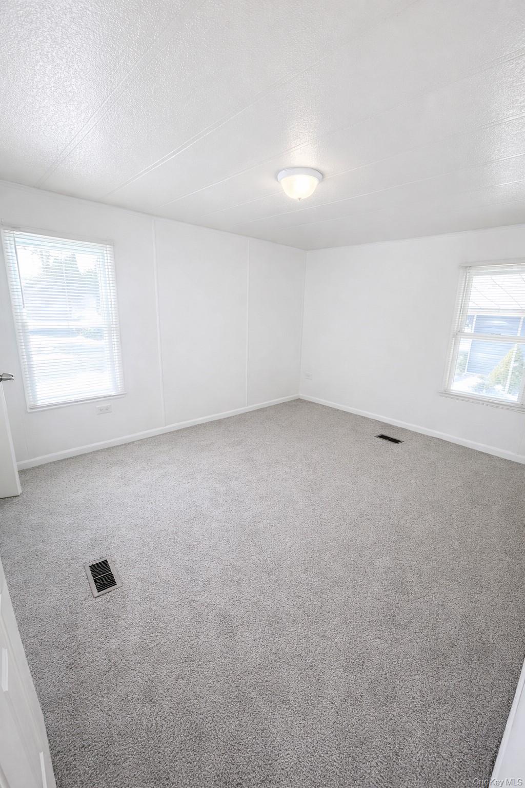 1661 Old Country Road, Unit 398 Riverhead, NY 11901 - Photo 9 of 14 an empty room with a window