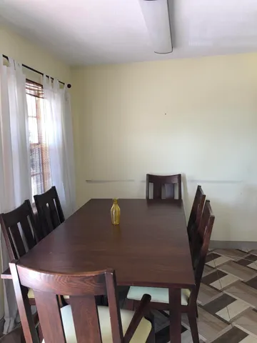 a view of a dining room with furniture and window