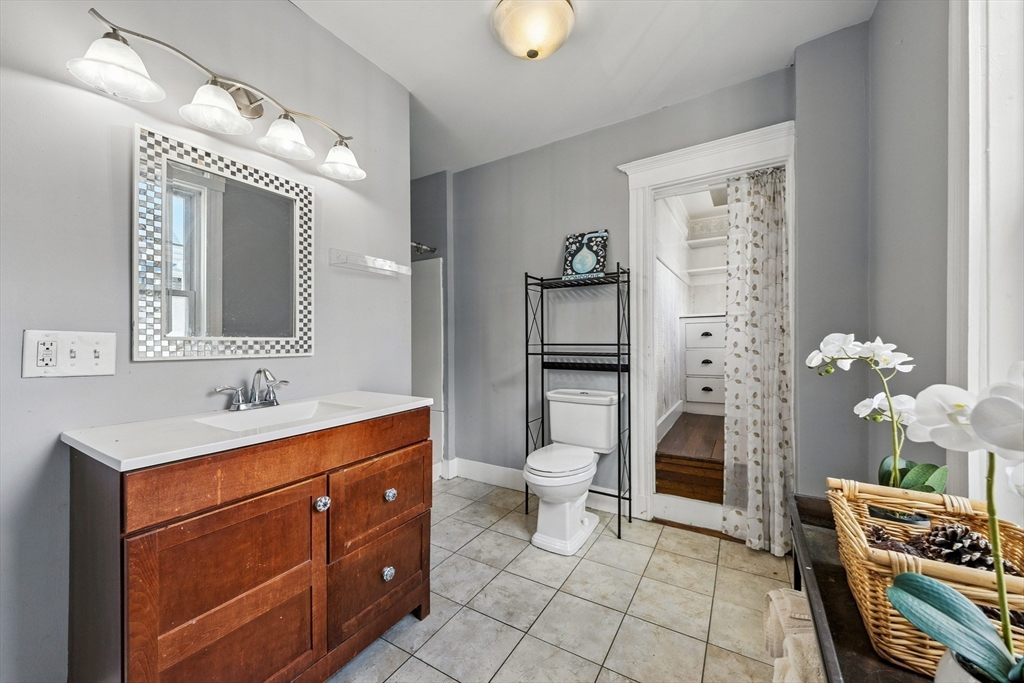 48 Harvard Street, Unit 1 Newton, MA 02460 - Photo 17 of 32 a spacious bathroom with a toilet sink and mirror