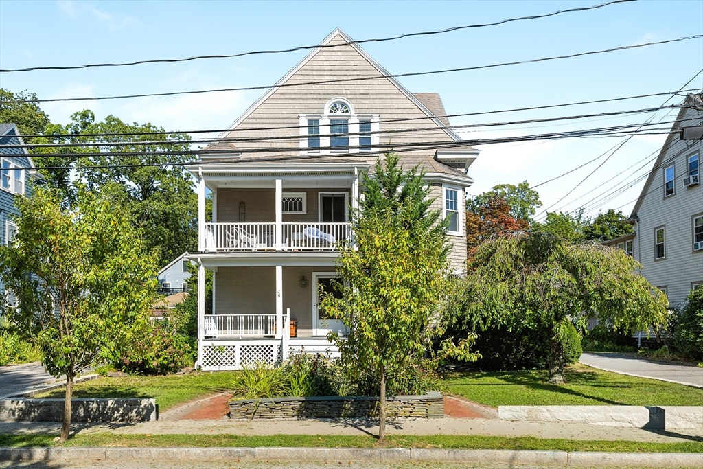 48 Harvard Street, Unit 1 Newton, MA 02460 - Photo 2 of 32 a front view of a house with a yard