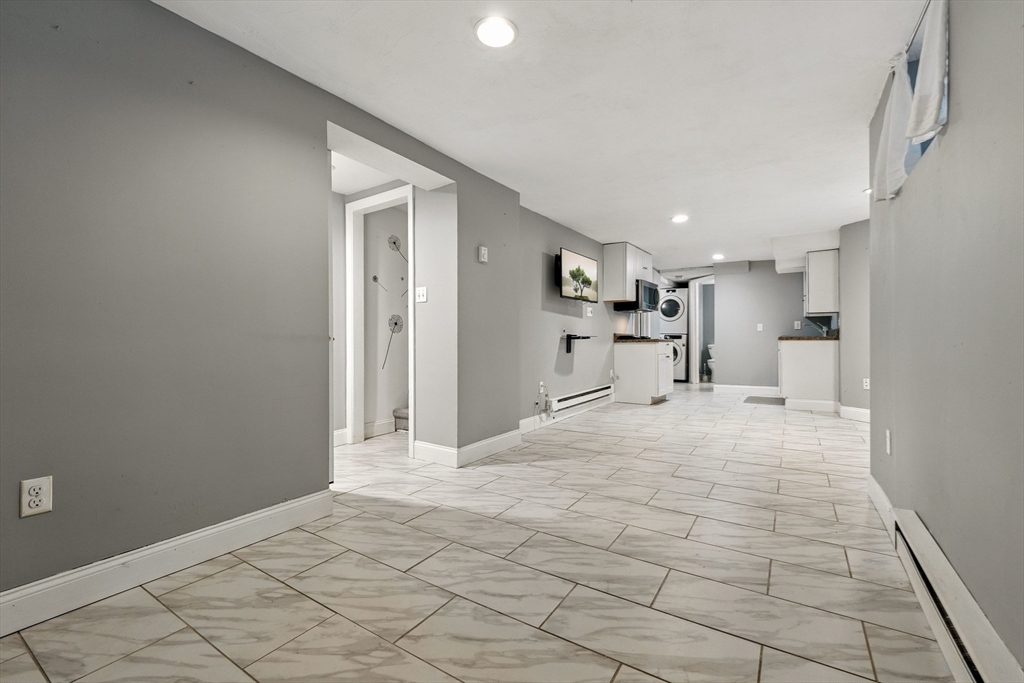 48 Harvard Street, Unit 1 Newton, MA 02460 - Photo 25 of 32 a big room with chandelier fan and windows