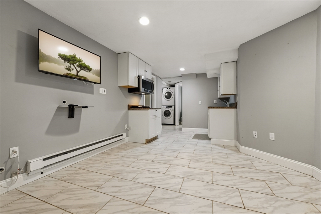 48 Harvard Street, Unit 1 Newton, MA 02460 - Photo 26 of 32 a view of kitchen with microwave cabinets and window