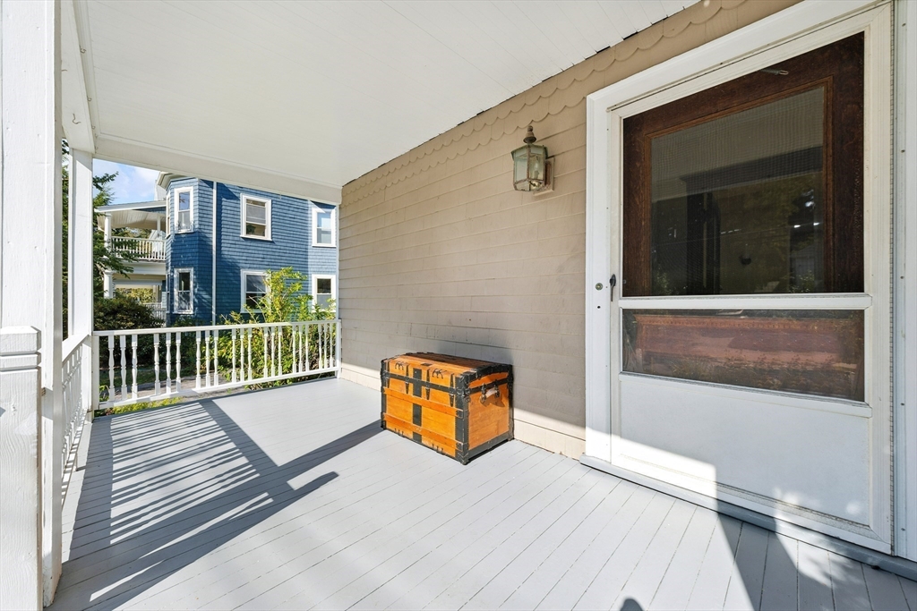 48 Harvard Street, Unit 1 Newton, MA 02460 - Photo 5 of 32 a view of a balcony with wooden floor
