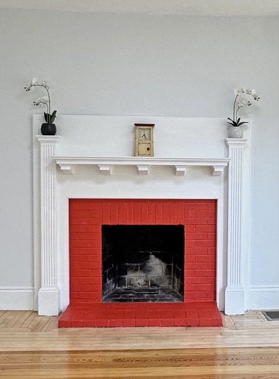 48 Harvard Street, Unit 1 Newton, MA 02460 - Photo 8 of 32 a fireplace with a fireplace