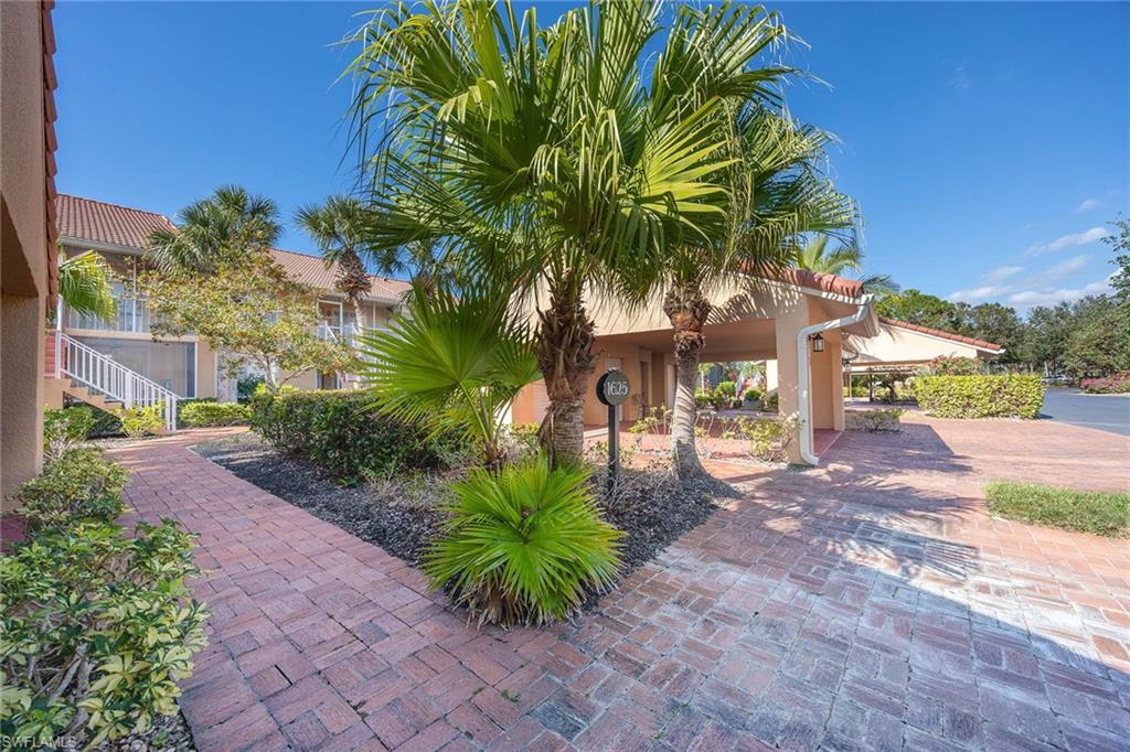 1625 Windy Pines Drive, Unit 5 Naples, FL 34112 - Photo 2 of 43 a view of a yard with a house