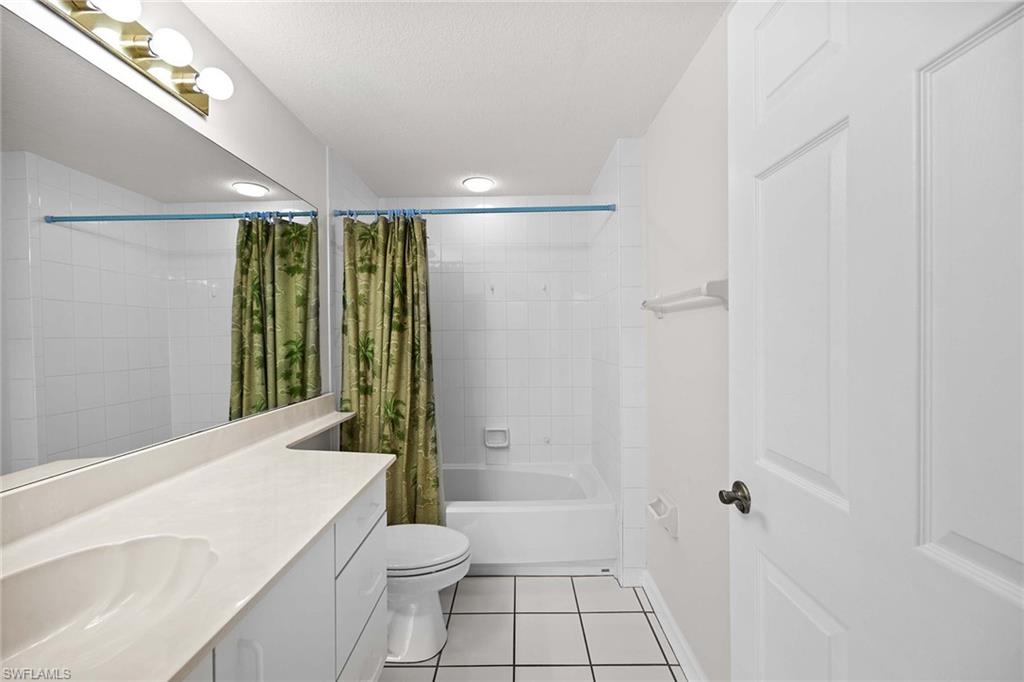 1625 Windy Pines Drive, Unit 5 Naples, FL 34112 - Photo 24 of 43 a bathroom with a toilet a sink and shower
