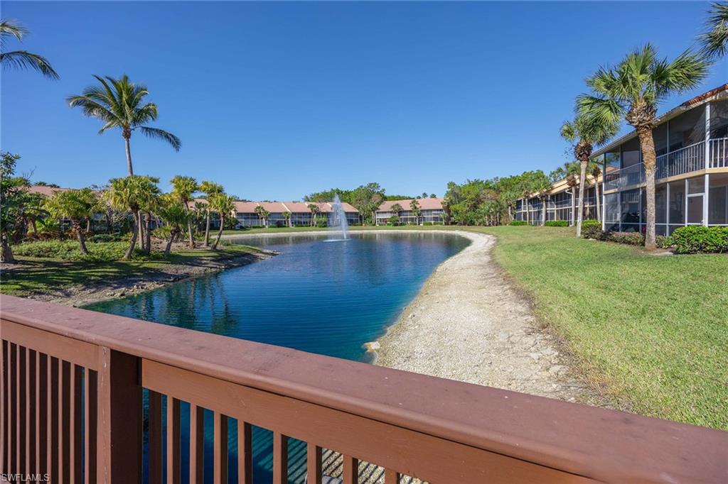 1625 Windy Pines Drive, Unit 5 Naples, FL 34112 - Photo 27 of 43 a view of a lake with a building in the background