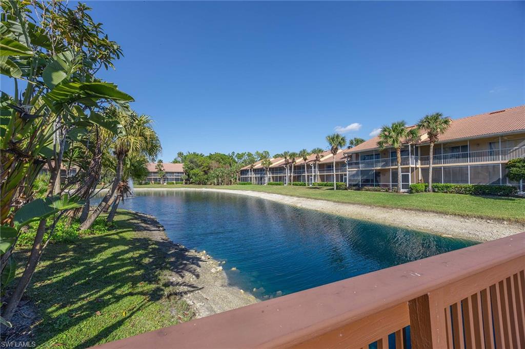 1625 Windy Pines Drive, Unit 5 Naples, FL 34112 - Photo 28 of 43 a view of a lake with a house in the background