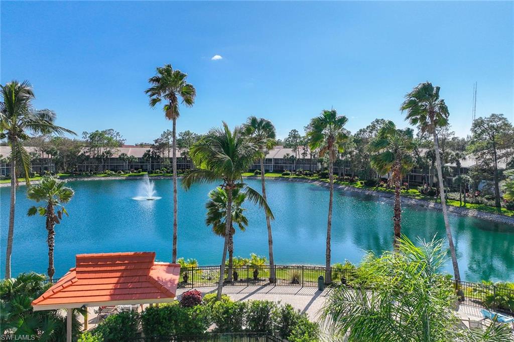 1625 Windy Pines Drive, Unit 5 Naples, FL 34112 - Photo 3 of 43 a view of a lake with a building in the background