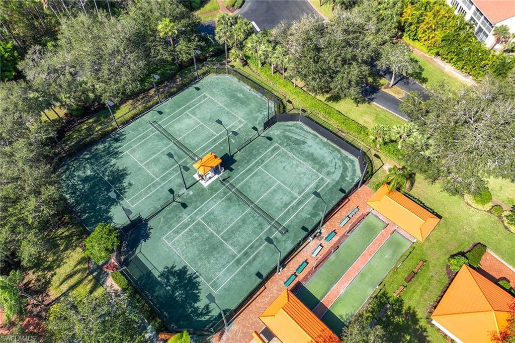 1625 Windy Pines Drive, Unit 5 Naples, FL 34112 - Photo 36 of 43 an aerial view of a tennis ground with a large tree