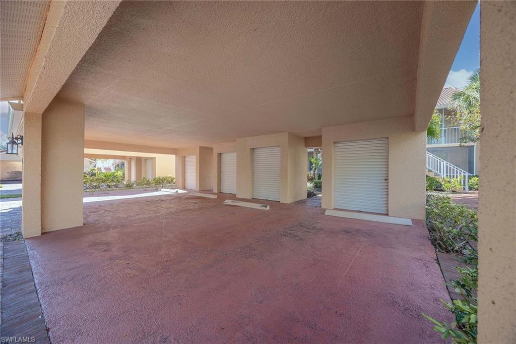 1625 Windy Pines Drive, Unit 5 Naples, FL 34112 - Photo 42 of 43 a view of a big room with windows and brick walls