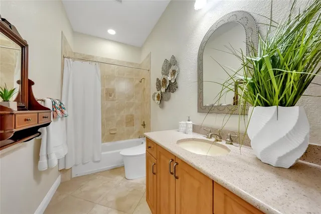 a bathroom with a granite countertop sink a toilet and a mirror