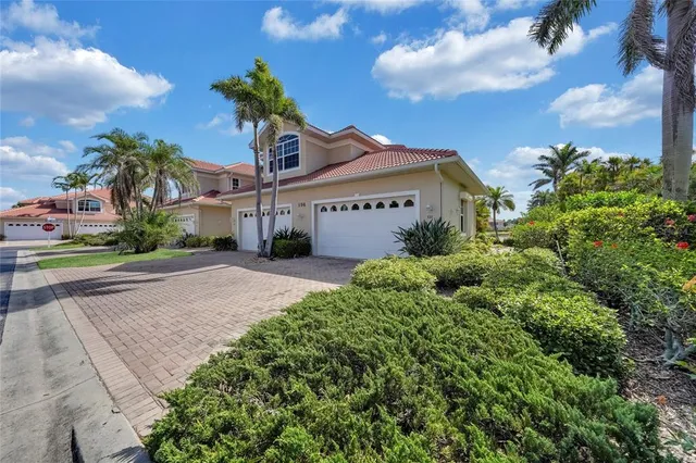 a front view of a house with a yard and potted plants
