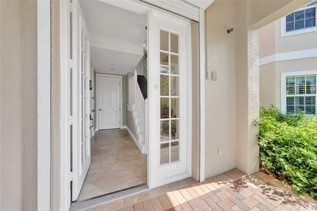 a view of a room with wooden floor and entryway
