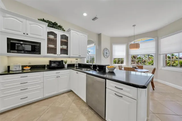 a kitchen with stainless steel appliances granite countertop a sink and cabinets