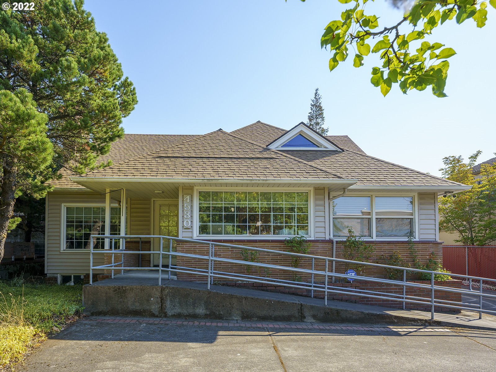a front view of a house with a garden