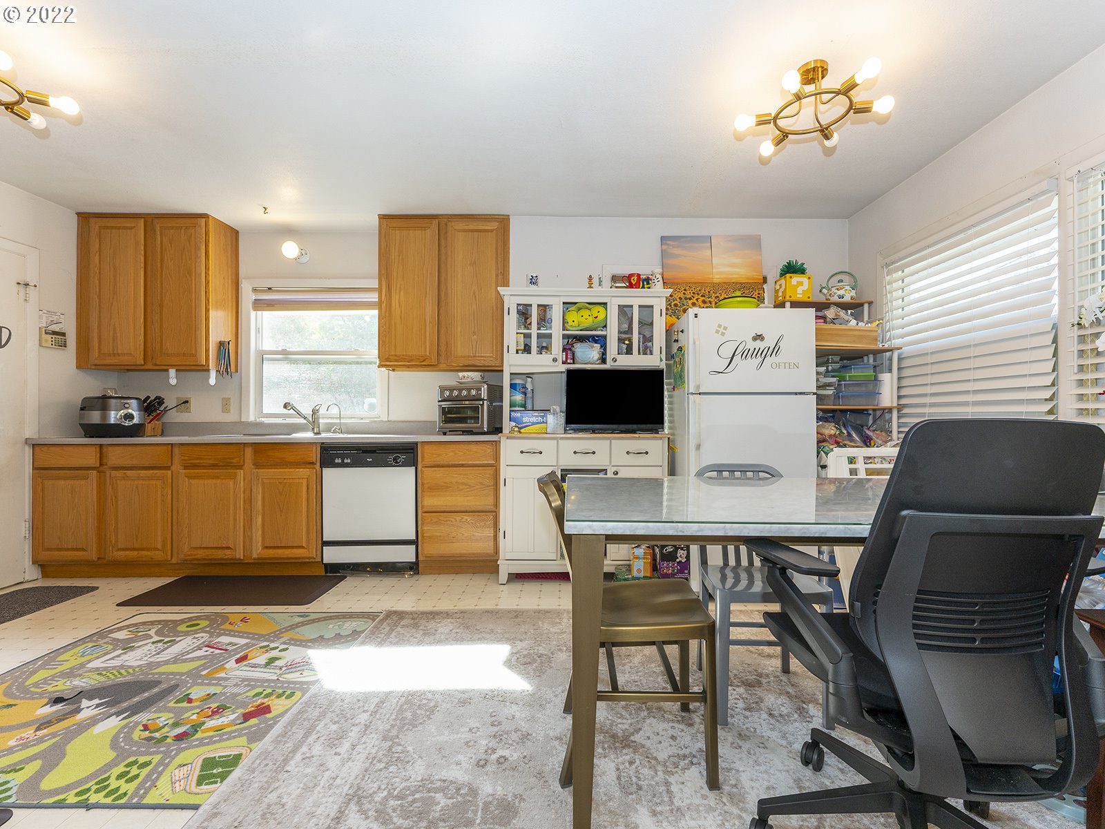4530 Southwest 110th Avenue Beaverton, OR 97005 - Photo 13 of 32 a kitchen with a table chairs and microwave