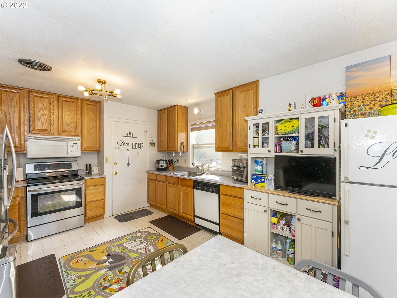 4530 Southwest 110th Avenue Beaverton, OR 97005 - Photo 14 of 32 a kitchen with stainless steel appliances kitchen island granite countertop a sink stove and refrigerator