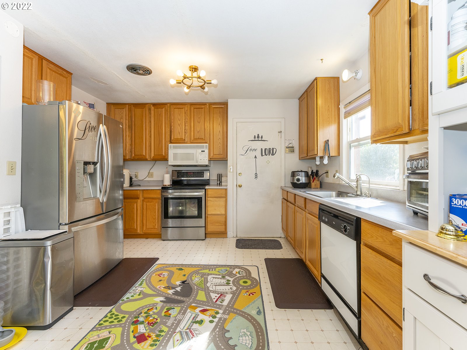 4530 Southwest 110th Avenue Beaverton, OR 97005 - Photo 15 of 32 a kitchen with stainless steel appliances granite countertop a refrigerator sink and stove