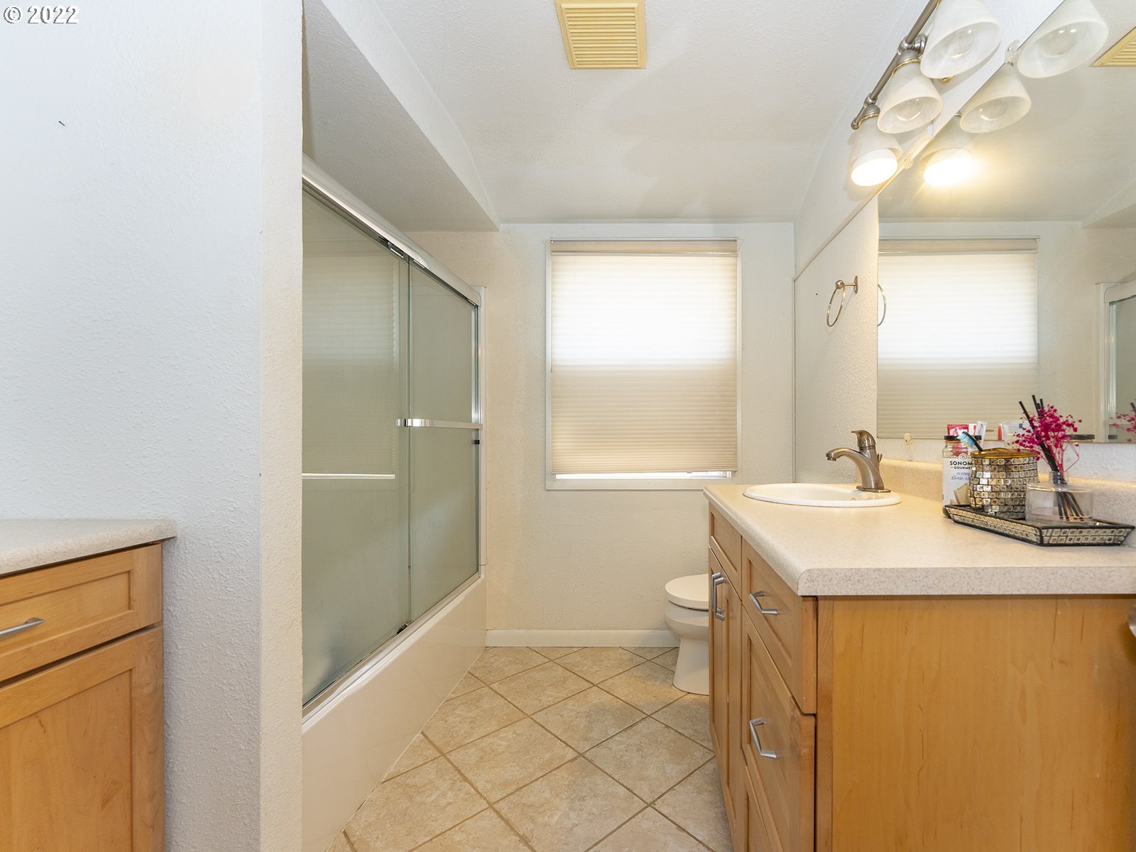 4530 Southwest 110th Avenue Beaverton, OR 97005 - Photo 24 of 32 a bathroom with a sink a mirror and a shower
