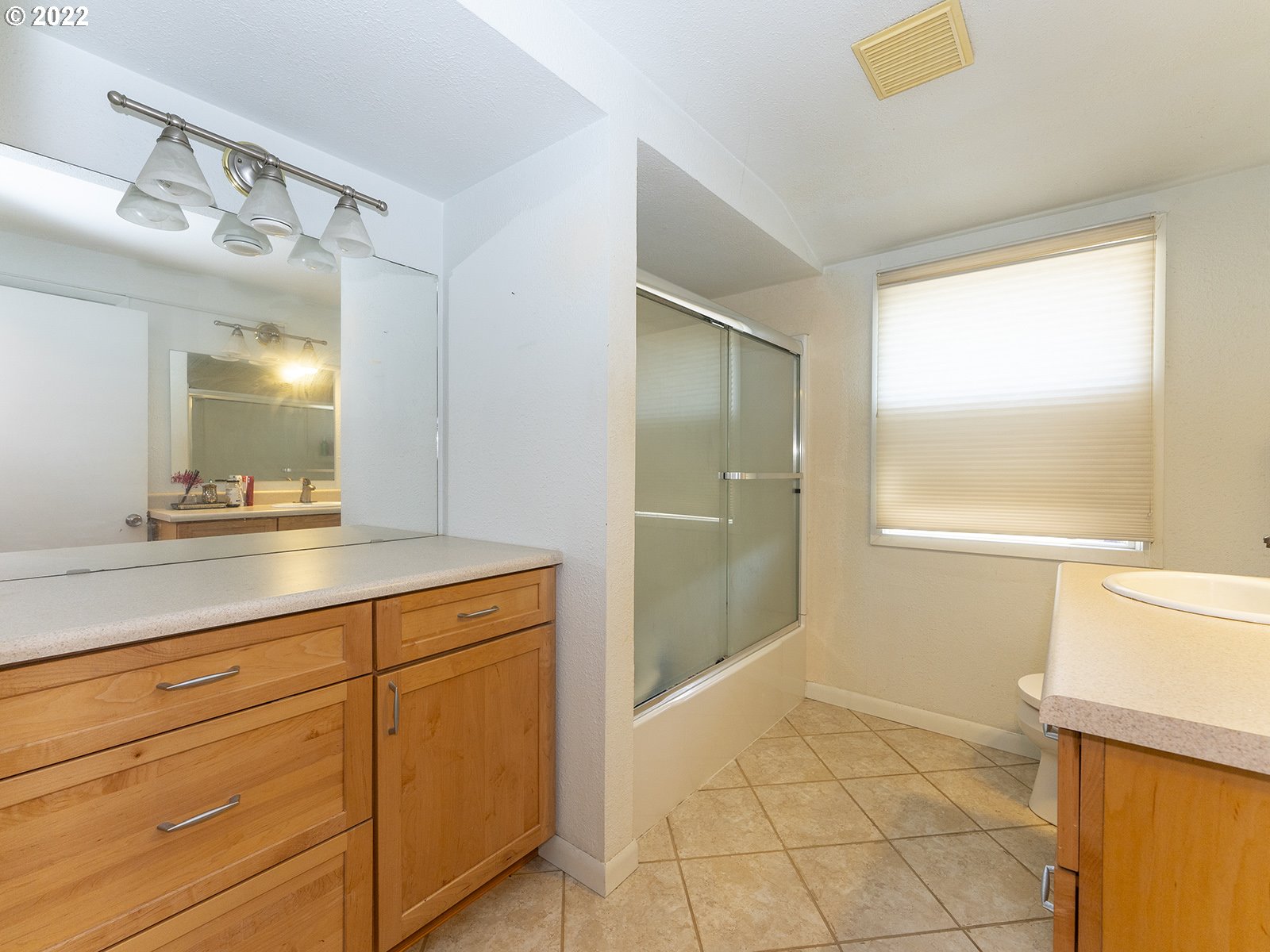 4530 Southwest 110th Avenue Beaverton, OR 97005 - Photo 25 of 32 a bathroom with a shower sink and mirror