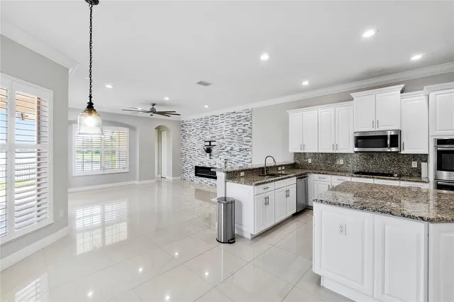 a kitchen with white cabinets and white appliances