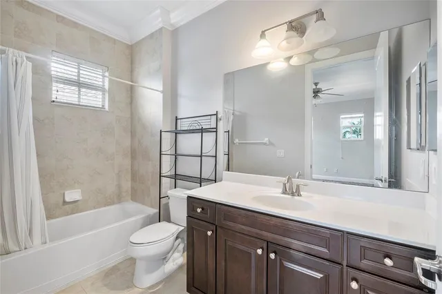 a bathroom with a sink a toilet a mirror and shower