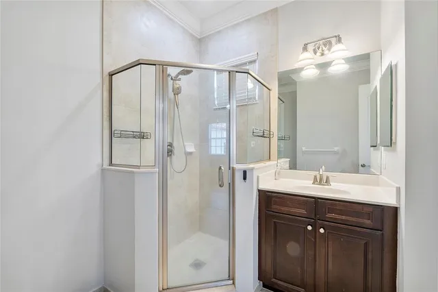 a bathroom with a shower sink and mirror