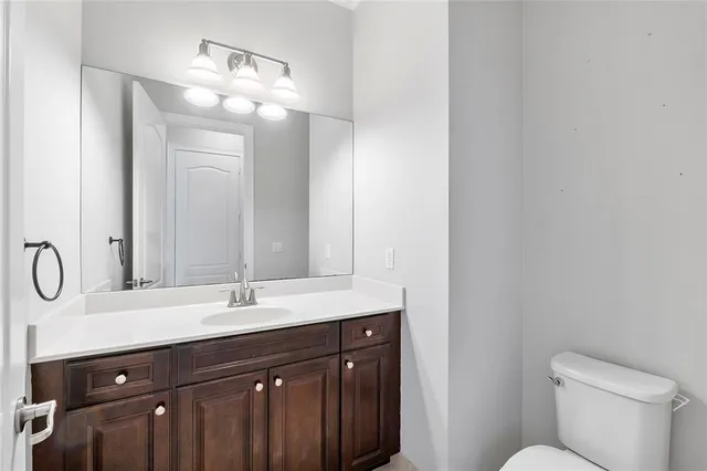 a bathroom with a double vanity sink and a toilet