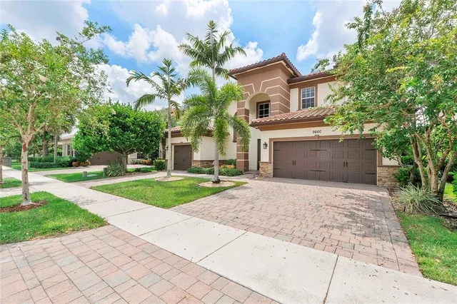 a front view of a house with a yard and a garage