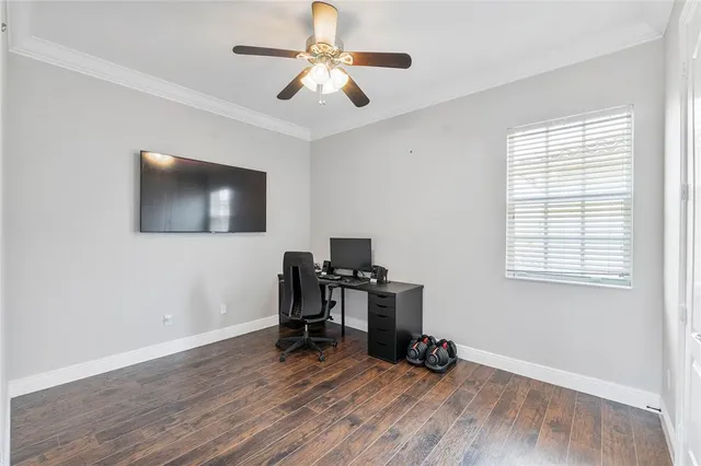a view of a workspace with furniture and a window