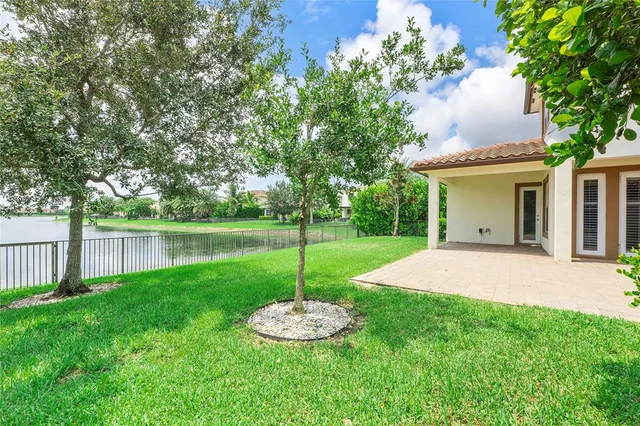 a view of a house with a yard and a garden