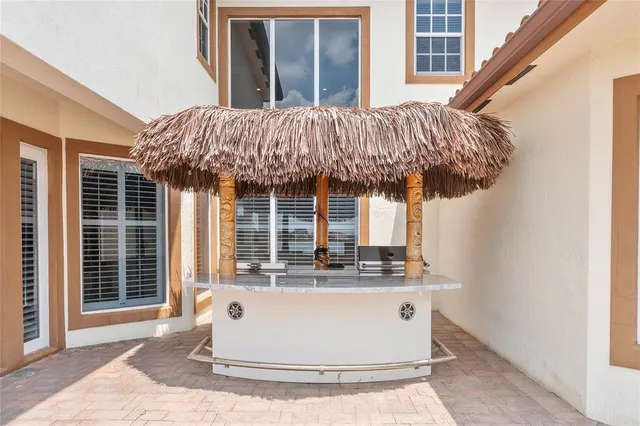 a view of kitchen with granite countertop window and outdoor kitchen